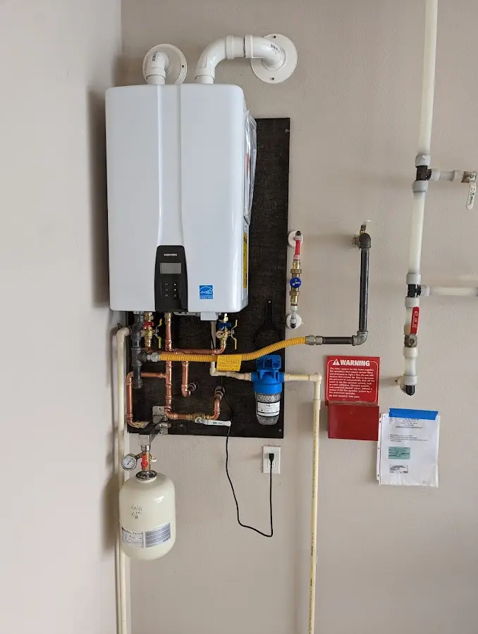 Professional plumber installing copper piping in a Halfmoon home